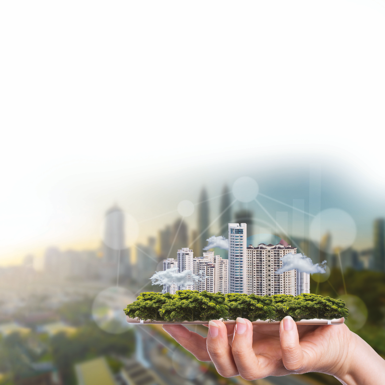 Hand holding a green city with trees